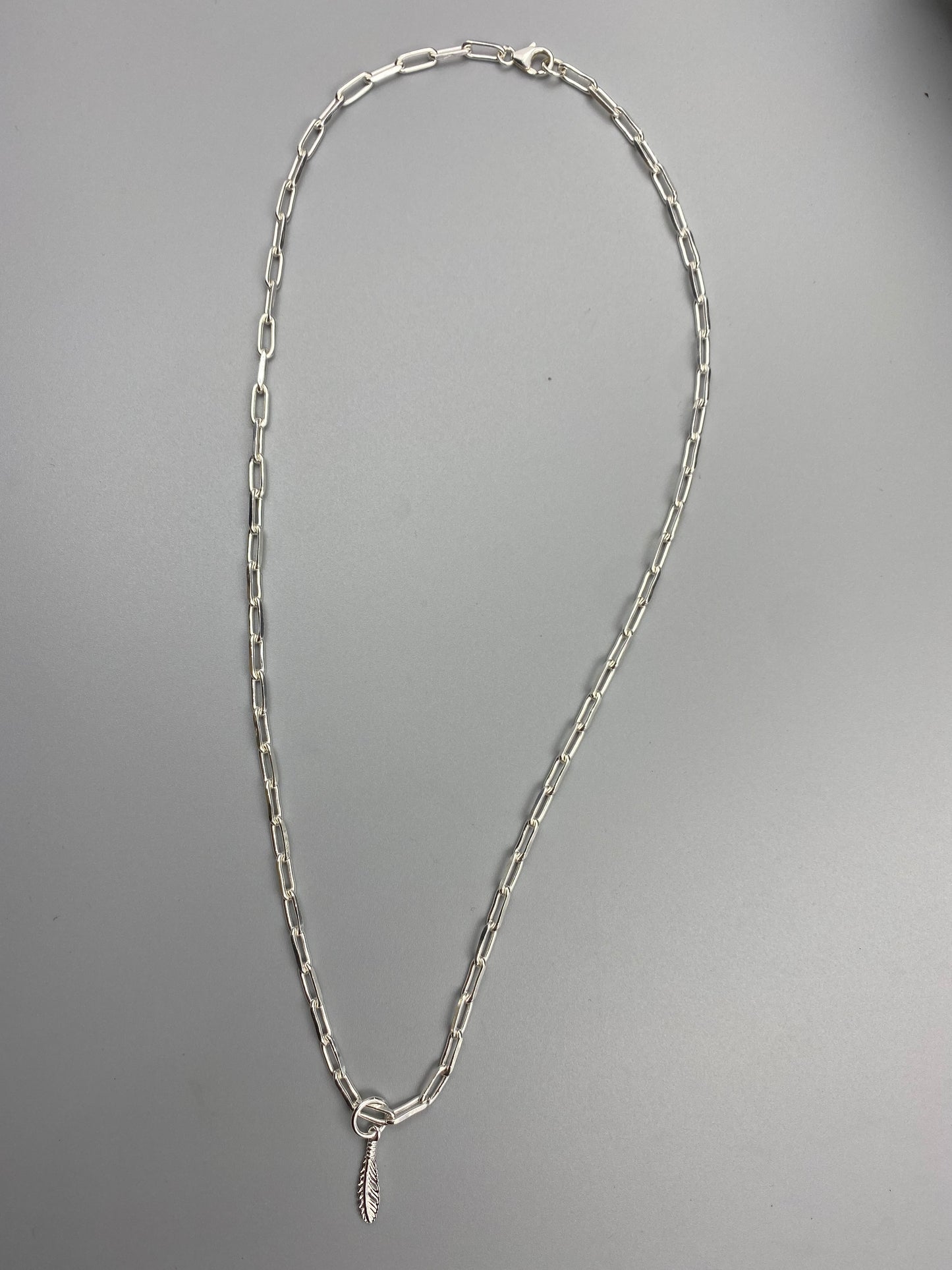 Feather charm trace chain necklace in Sterling Silver