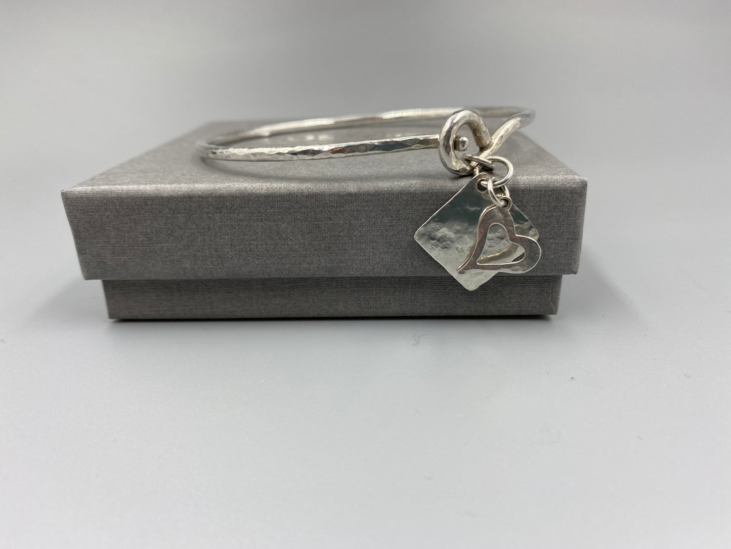 Sterling silver heart and square charm clasp bangle