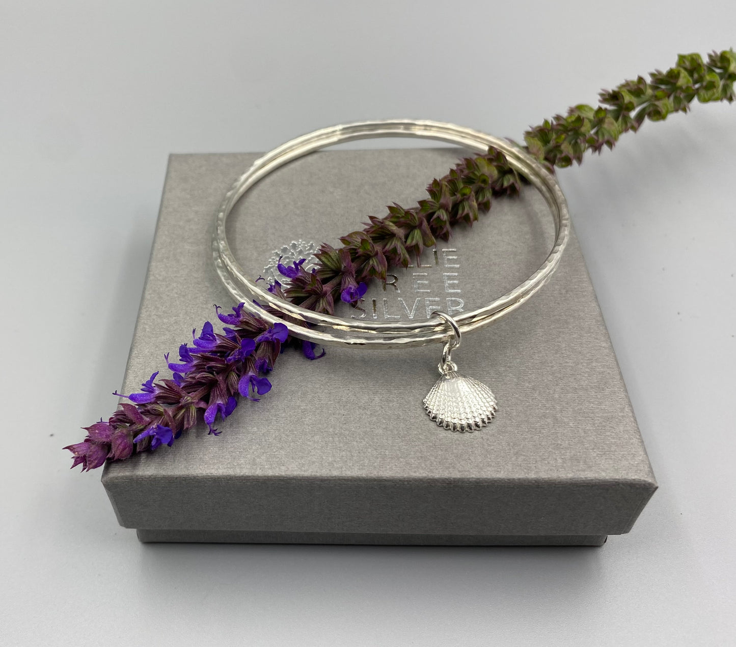 Sterling silver double dimple texture stacker bangle with scallop shell charm