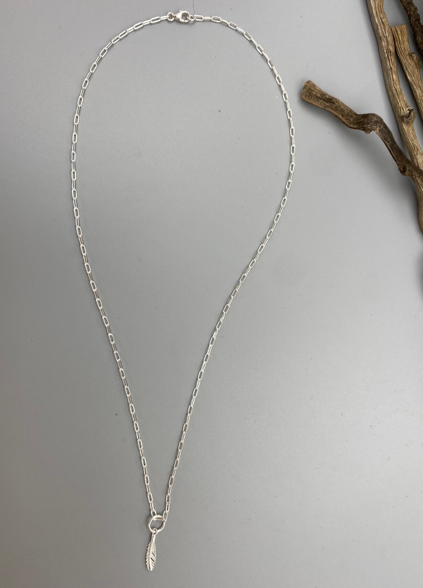 Feather charm skinny trace chain necklace in Sterling Silver