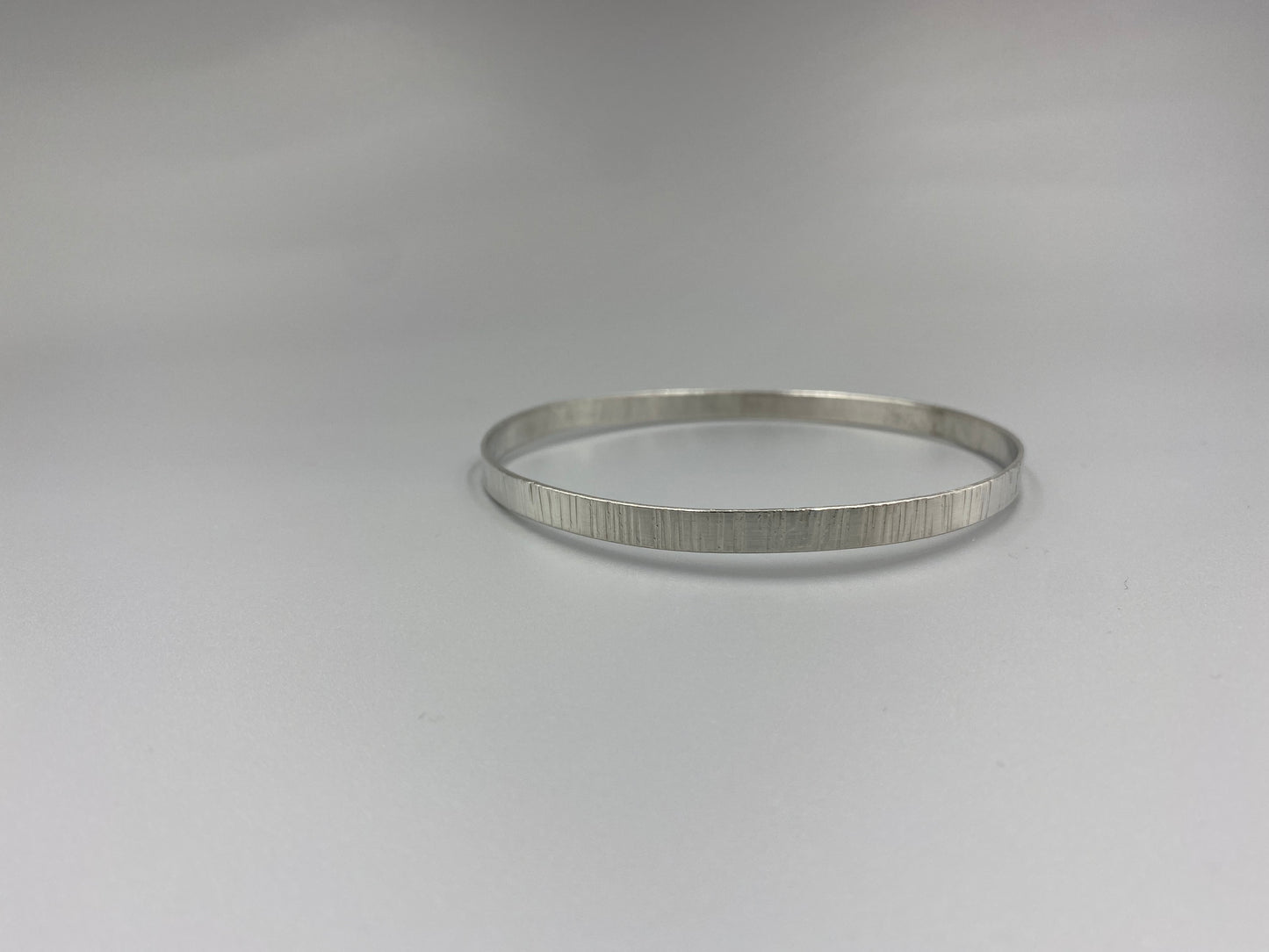 Sterling silver linear texture flat stacker bangle