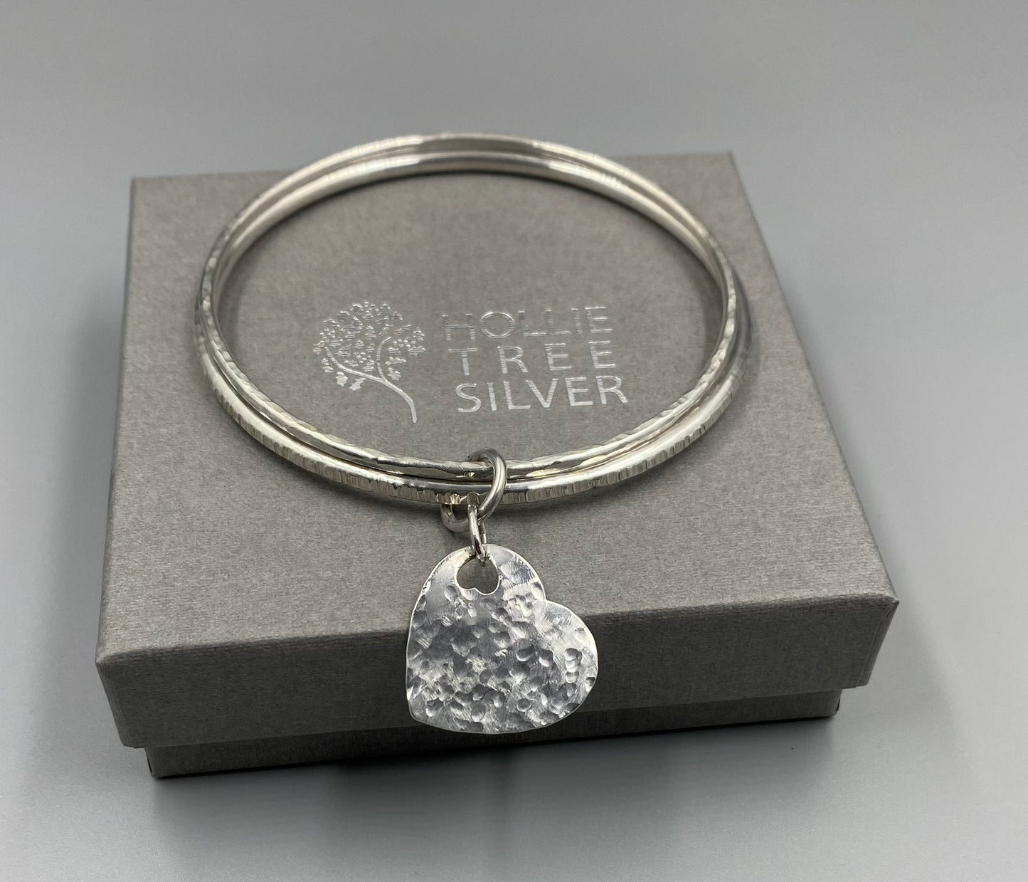 Sterling silver dimple and linear texture double bangle with a heart charm